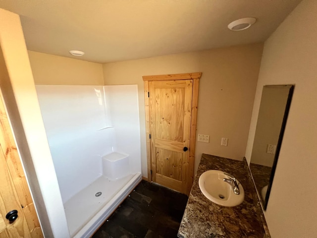full bathroom featuring vanity and a stall shower