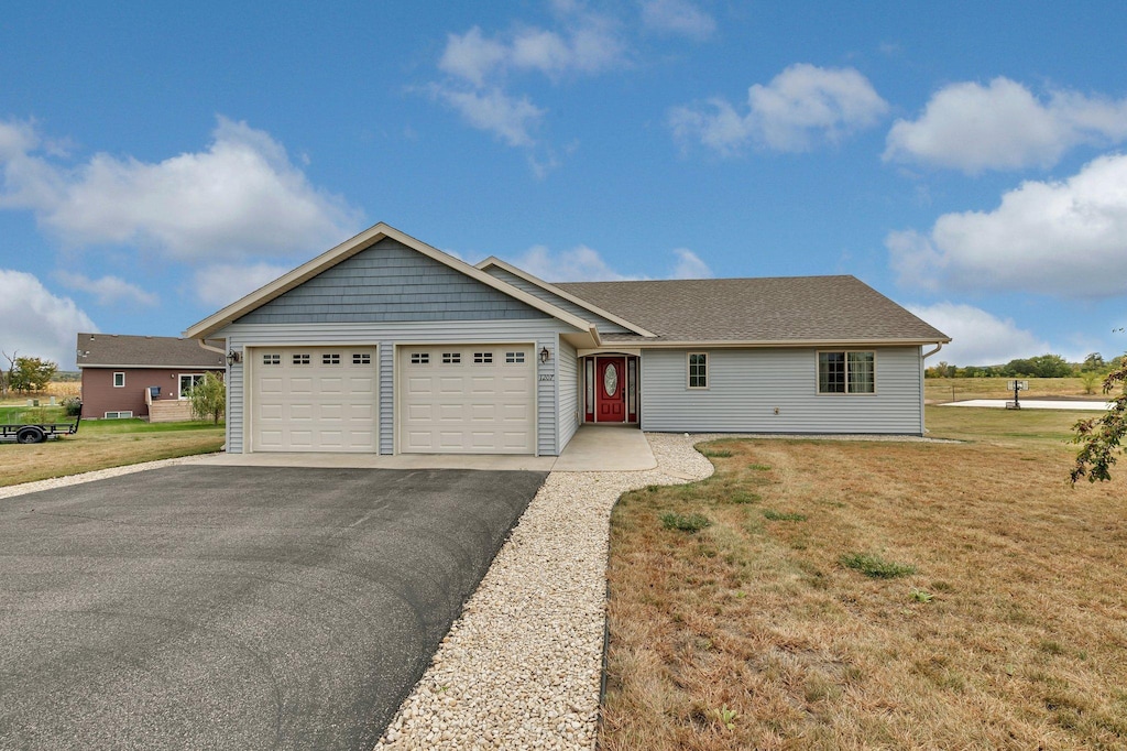 view of front of home with a garage and a front lawn