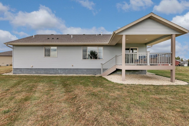 back of property featuring a deck and a yard