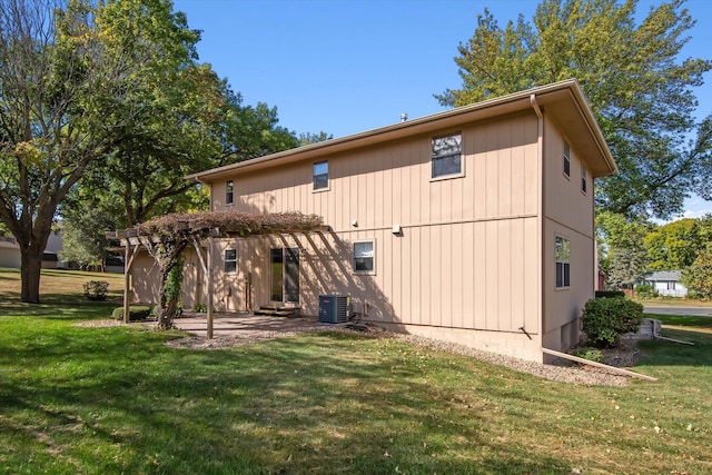 back of property with cooling unit and a lawn