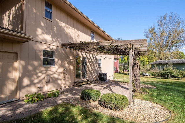 exterior space featuring a patio, a lawn, a pergola, and central AC unit