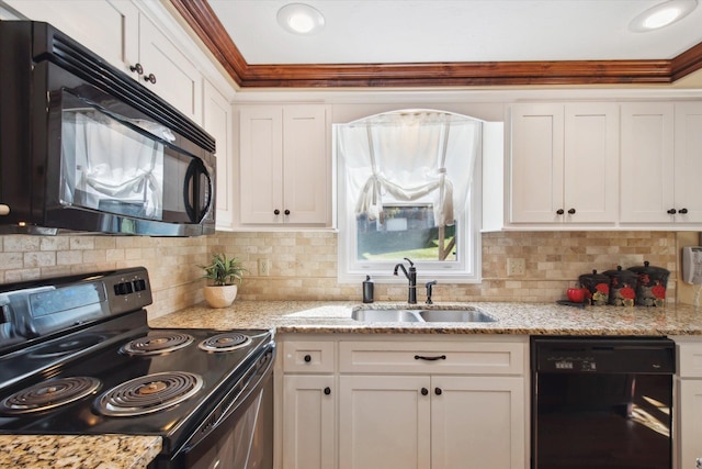 kitchen with sink, light stone countertops, backsplash, black appliances, and white cabinetry