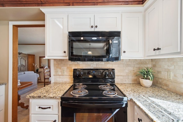 kitchen featuring tasteful backsplash, crown molding, light stone countertops, black appliances, and white cabinetry