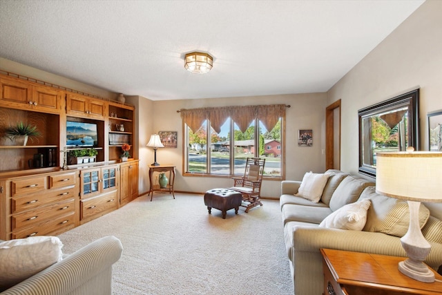 living room featuring carpet floors, a wealth of natural light, and a textured ceiling