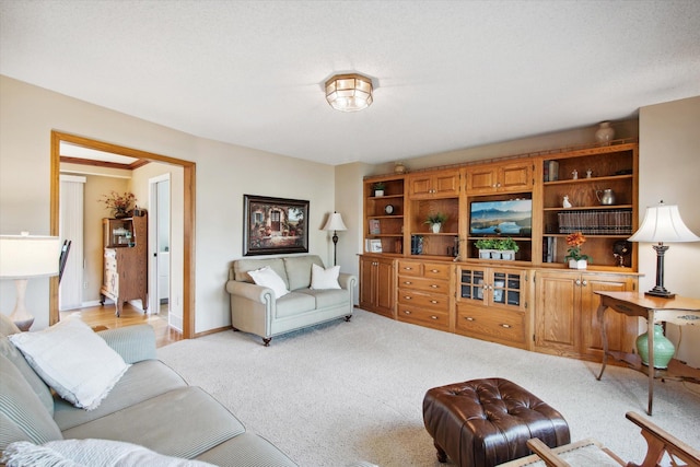 living room featuring a textured ceiling and light colored carpet