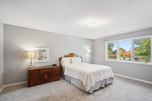 carpeted bedroom featuring a textured ceiling