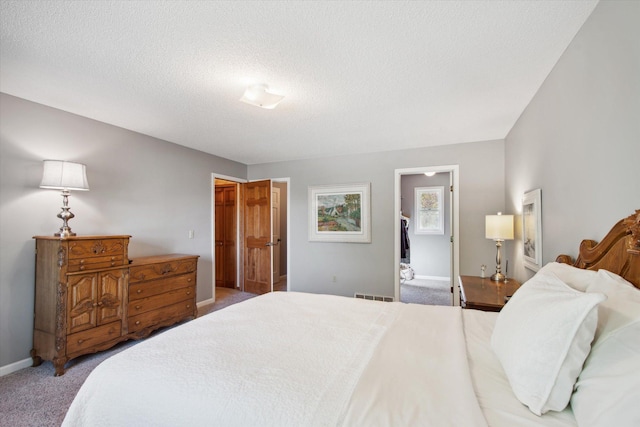 carpeted bedroom featuring a textured ceiling