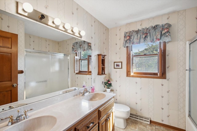 bathroom featuring vanity, plenty of natural light, and toilet