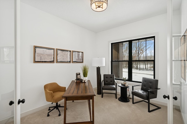 office area featuring french doors, baseboards, and light colored carpet