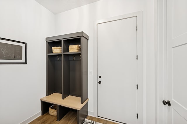 mudroom featuring wood finished floors and baseboards