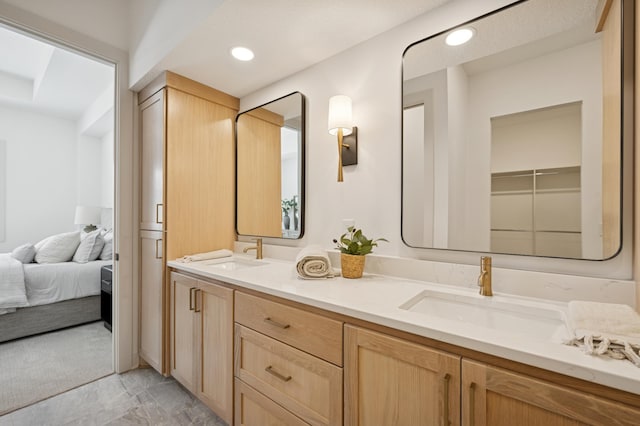 ensuite bathroom featuring ensuite bath, double vanity, recessed lighting, and a sink