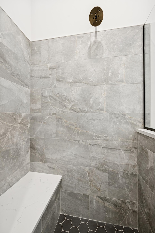 bathroom with a tile shower