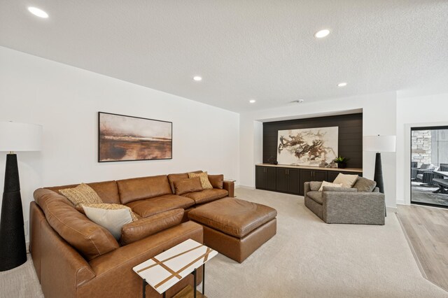 living room featuring recessed lighting and a textured ceiling