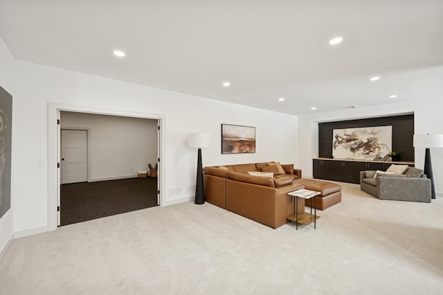 carpeted living room with recessed lighting and baseboards