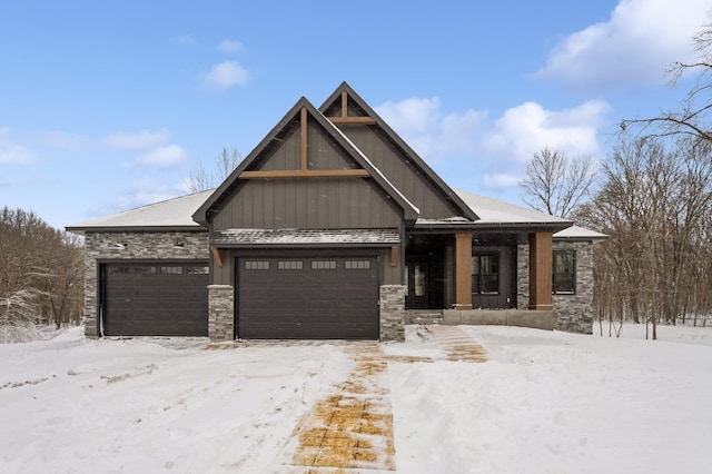 view of front of home featuring an attached garage and stone siding