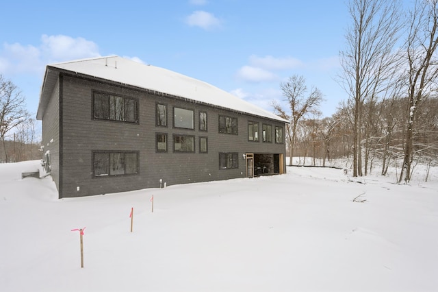 view of snow covered rear of property