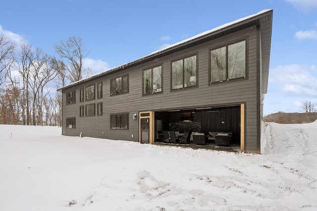 snow covered house featuring a garage