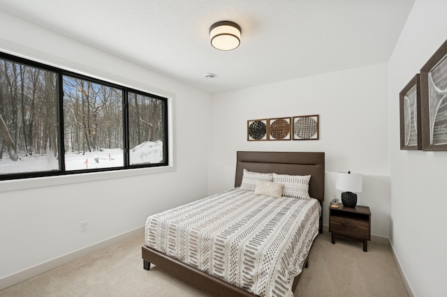 bedroom featuring carpet flooring and baseboards