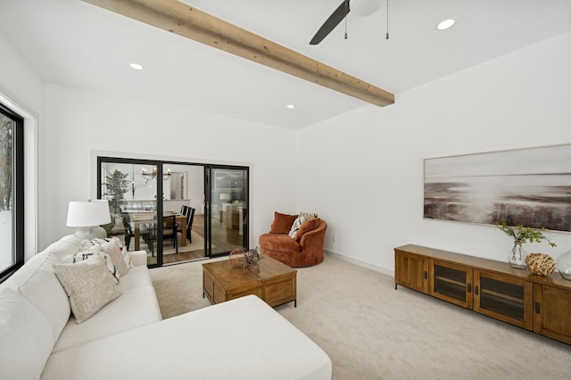living area with beam ceiling, carpet flooring, a healthy amount of sunlight, and ceiling fan