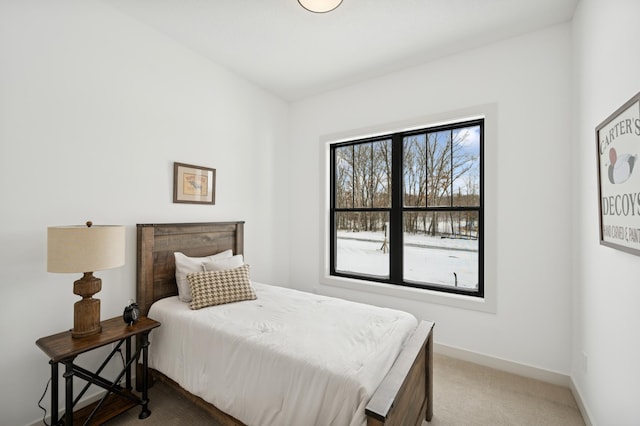 bedroom featuring baseboards, multiple windows, and carpet flooring