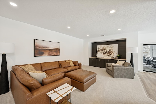 living room with recessed lighting and a textured ceiling