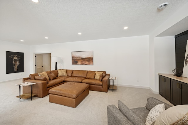 living room featuring light carpet, recessed lighting, a textured ceiling, and baseboards