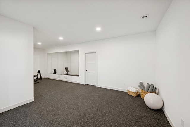 workout area featuring recessed lighting and baseboards