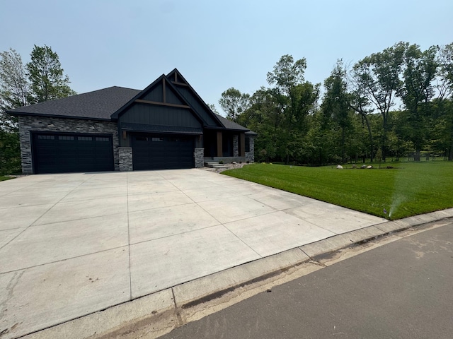 14805 Stutz St NE, Ham Lake, MN 55304 - craftsman house featuring a front yard, a garage, driveway, and stone siding