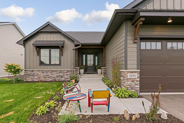 property entrance featuring a lawn and a garage