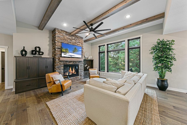 living room with beam ceiling, ceiling fan, dark hardwood / wood-style floors, and a fireplace