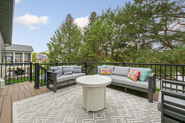 wooden terrace with an outdoor living space