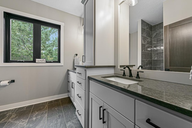 bathroom with a textured ceiling and vanity