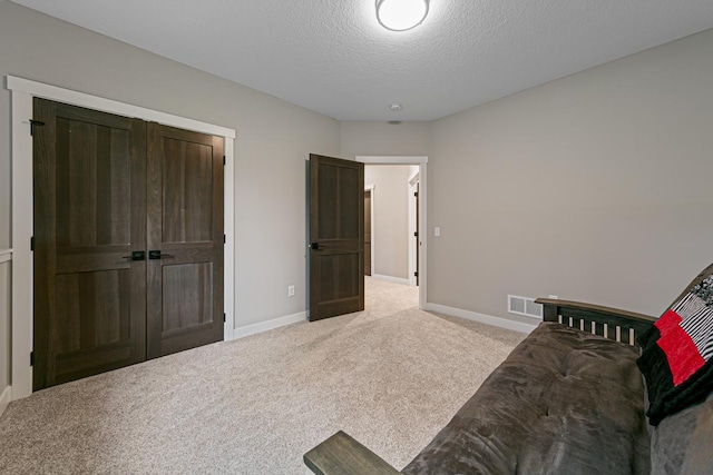 interior space featuring carpet and a textured ceiling