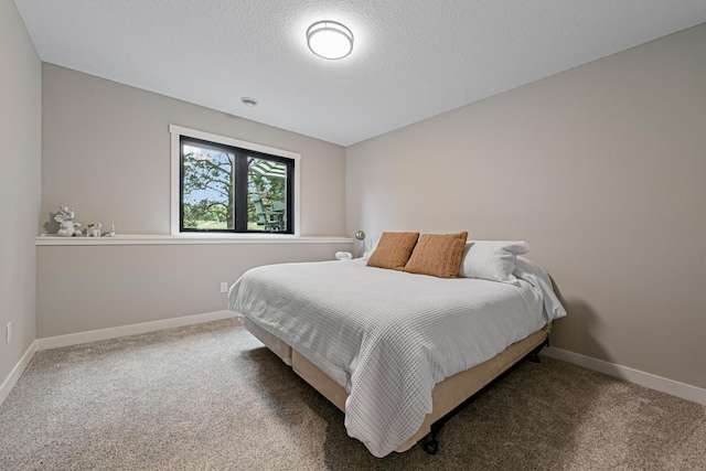 carpeted bedroom featuring a textured ceiling