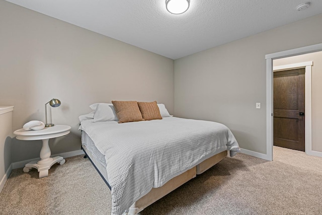 bedroom with carpet and a textured ceiling