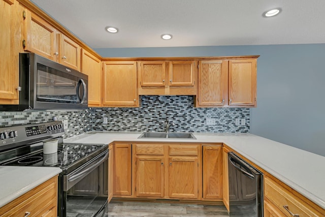 kitchen with light hardwood / wood-style floors, decorative backsplash, stainless steel appliances, and sink