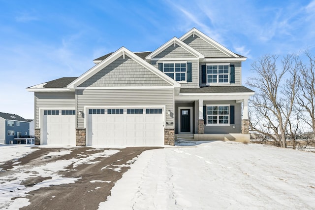 craftsman-style home featuring stone siding and an attached garage