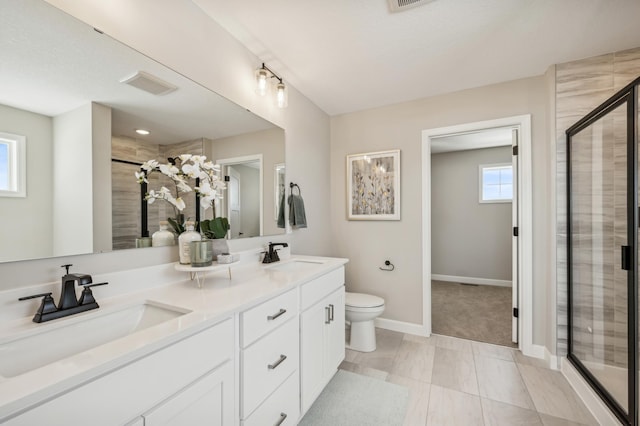 bathroom featuring a stall shower, a sink, and double vanity