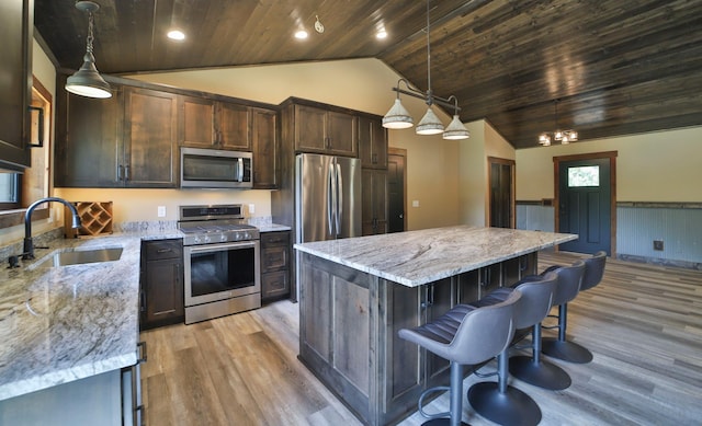 kitchen with wood ceiling, sink, lofted ceiling, appliances with stainless steel finishes, and decorative light fixtures