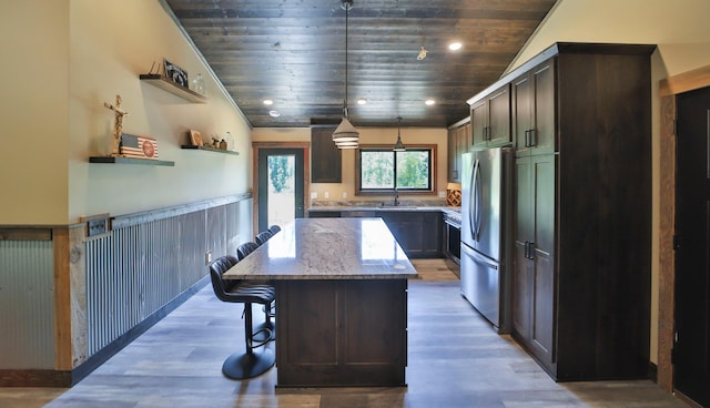 kitchen featuring light stone counters, decorative light fixtures, wood ceiling, and a kitchen island