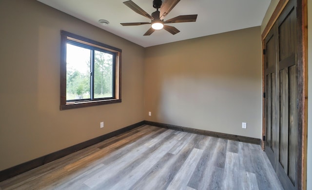 spare room featuring light hardwood / wood-style floors and ceiling fan