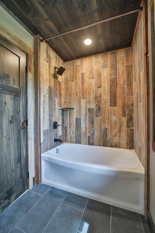 bathroom with tiled shower / bath combo and tile patterned flooring