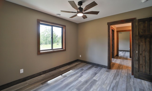 empty room with ceiling fan and hardwood / wood-style floors