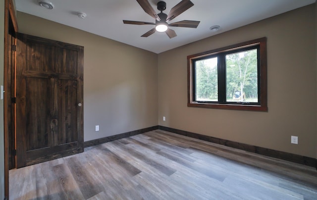 empty room with light hardwood / wood-style flooring and ceiling fan