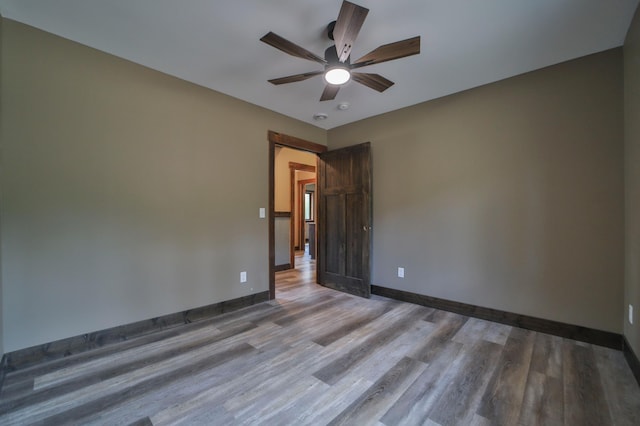 spare room featuring hardwood / wood-style floors and ceiling fan