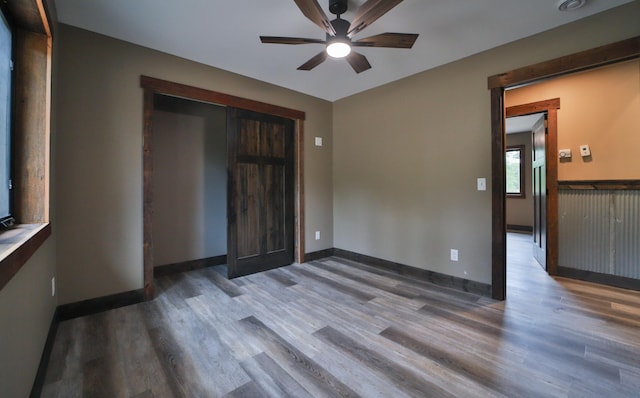 empty room featuring ceiling fan and dark hardwood / wood-style flooring