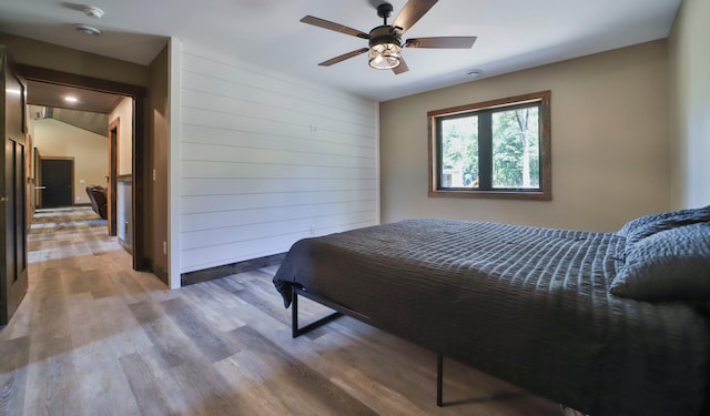 bedroom featuring ceiling fan, lofted ceiling, and hardwood / wood-style floors