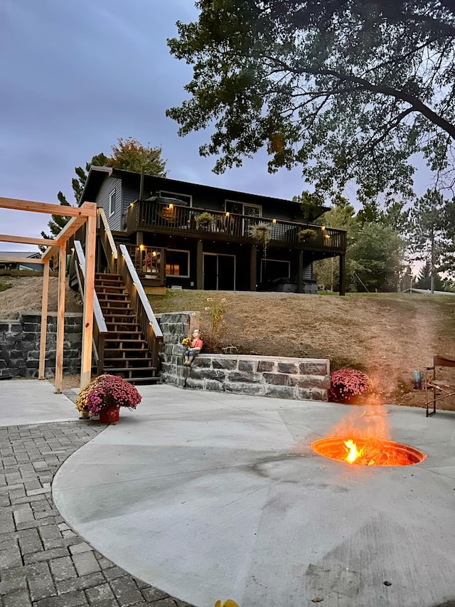 exterior space featuring a wooden deck and a patio