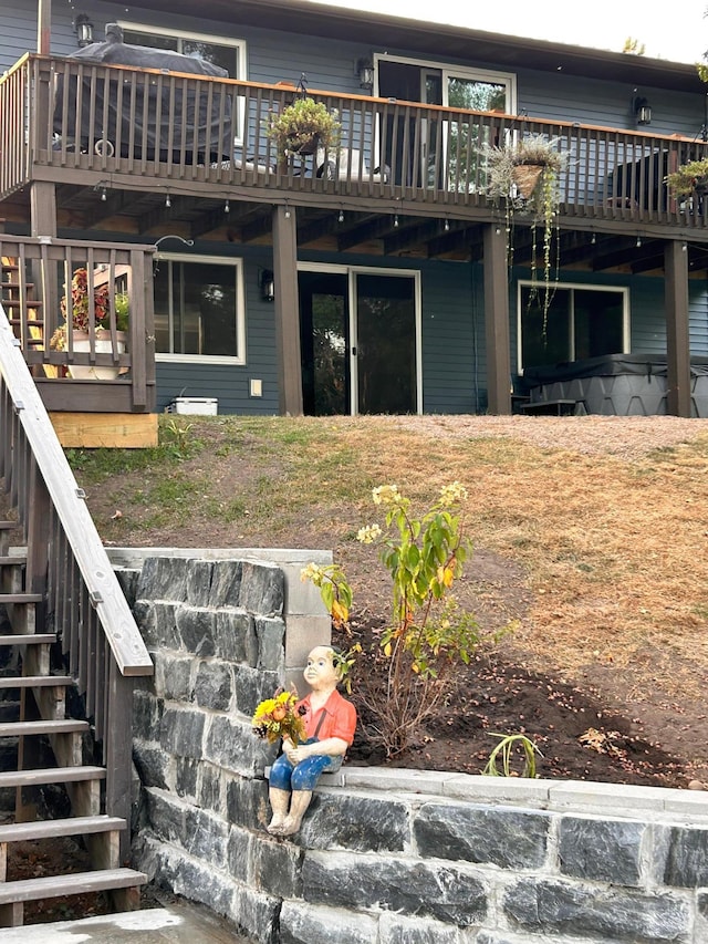 back of house featuring a wooden deck