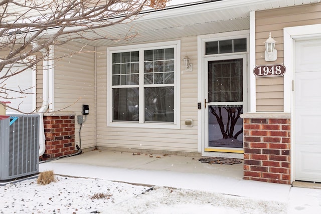 view of exterior entry with central AC unit